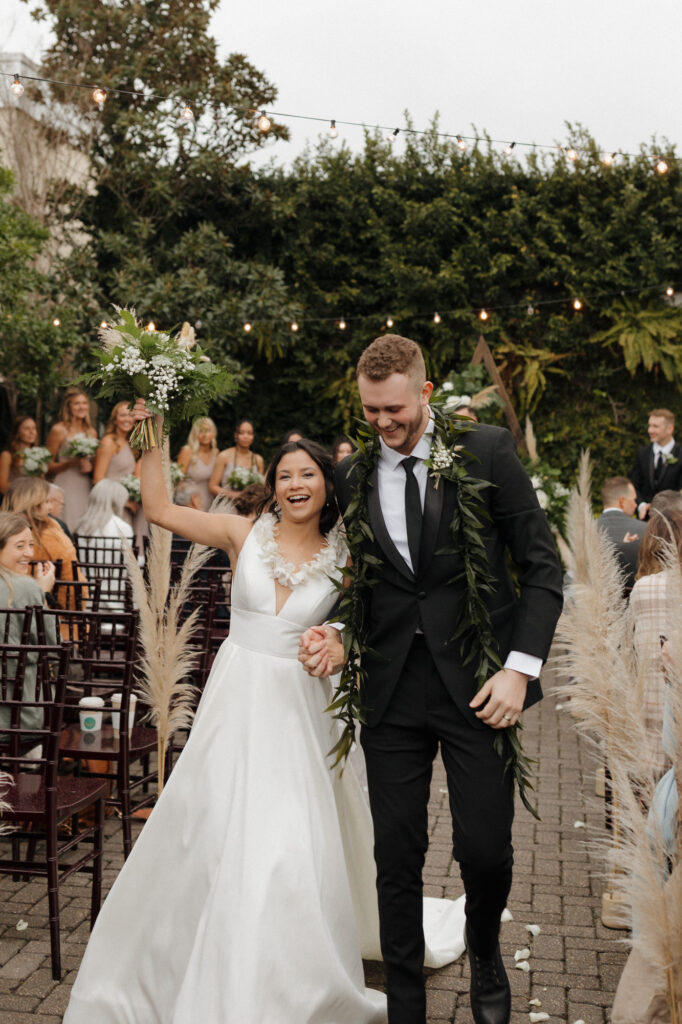 Ceremony with bride and groom in courtyard at 5eleven palafox