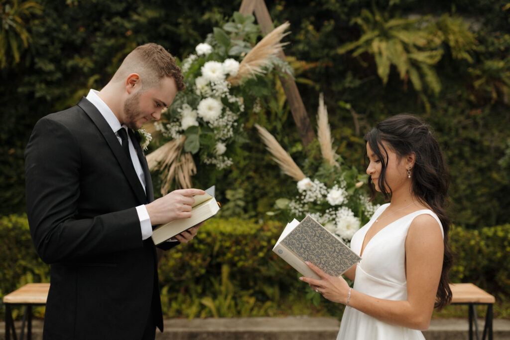 Bride and groom exchanging bibles at wedding