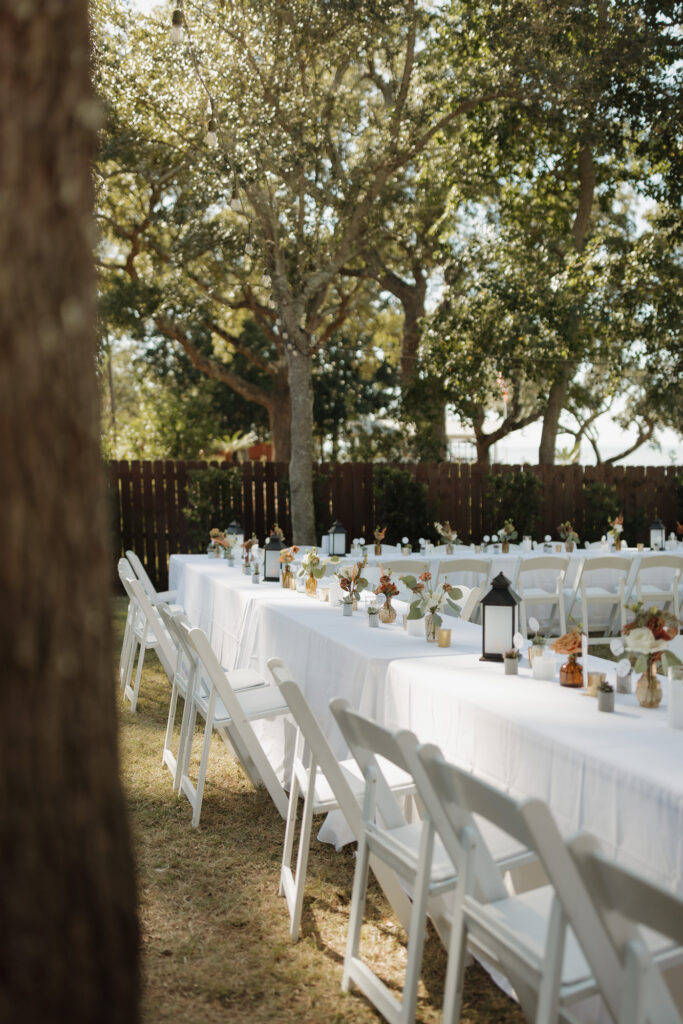 Moody tablescape with florals and candlelight at Florida waterfront wedding