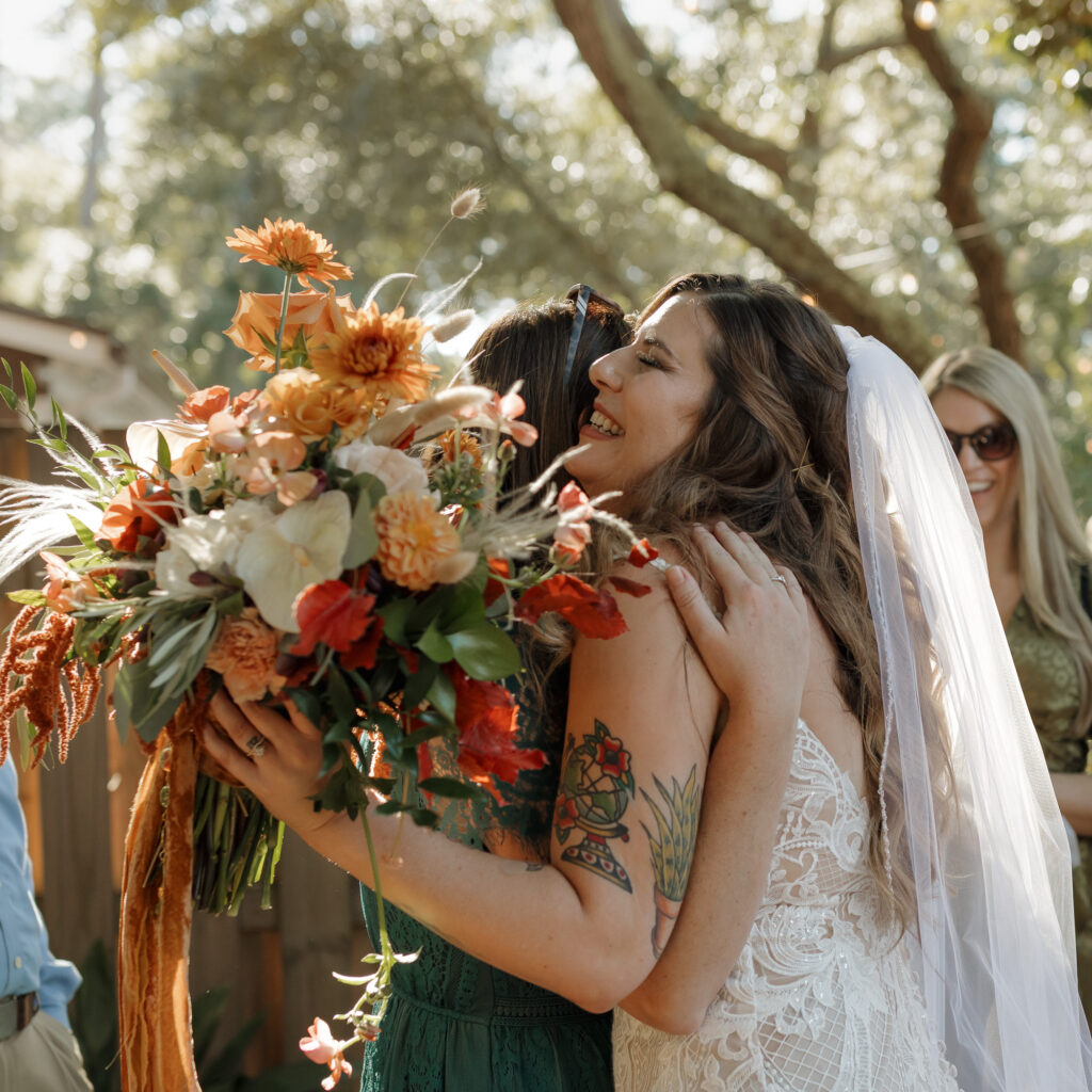 bride hugging family after getting married