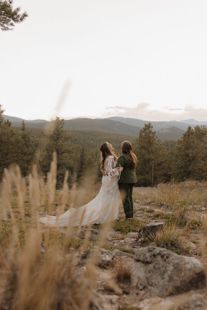 Couple embracing at golden hour during LGBTQ wedding in Colorado