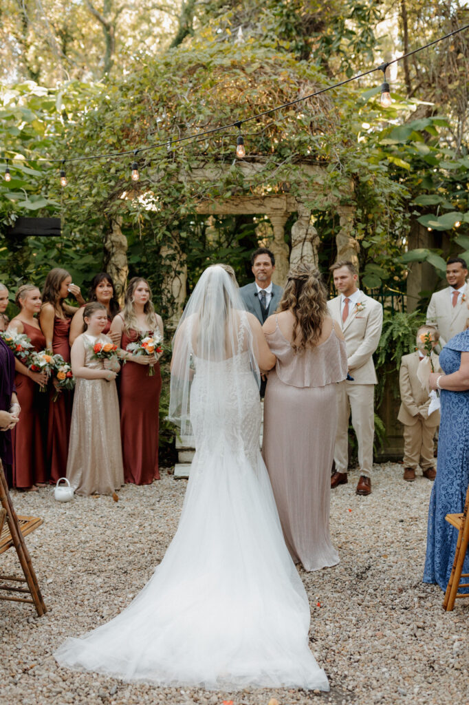 mom walking bride down aisle at intimate garden ceremony in 30a florida