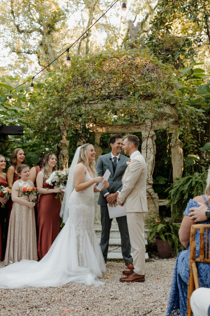 bride and groom sharing personal vows at outdoor garden wedding