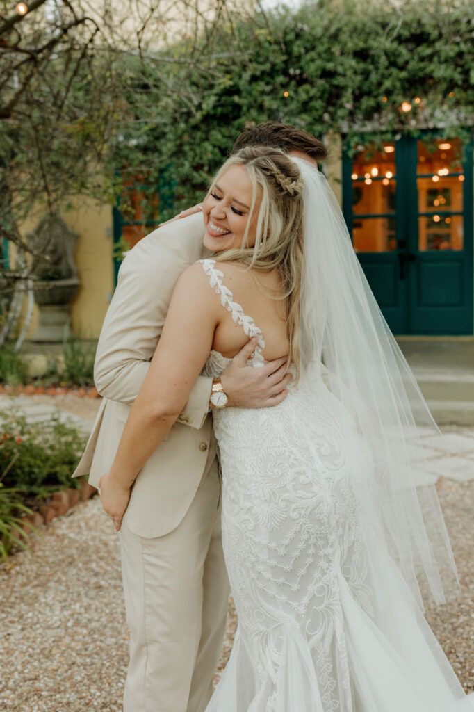 bride smiling and grabbing groom's butt after emotional ceremony