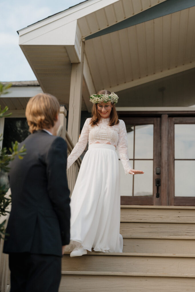 Bride and groom seeing each other for the first time on the front steps of a quiet beach house in Perdido Key